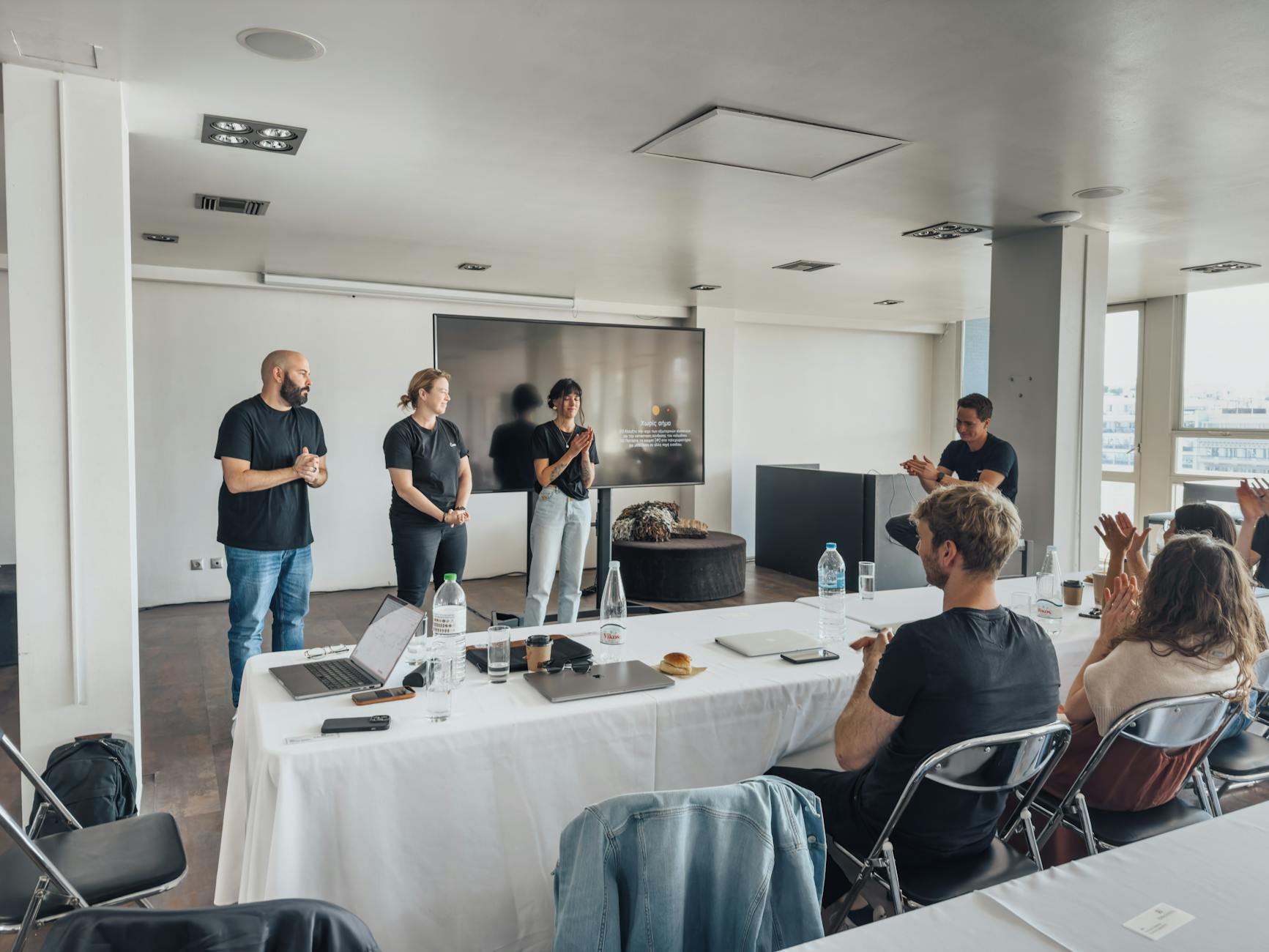 a group of people standing around a table